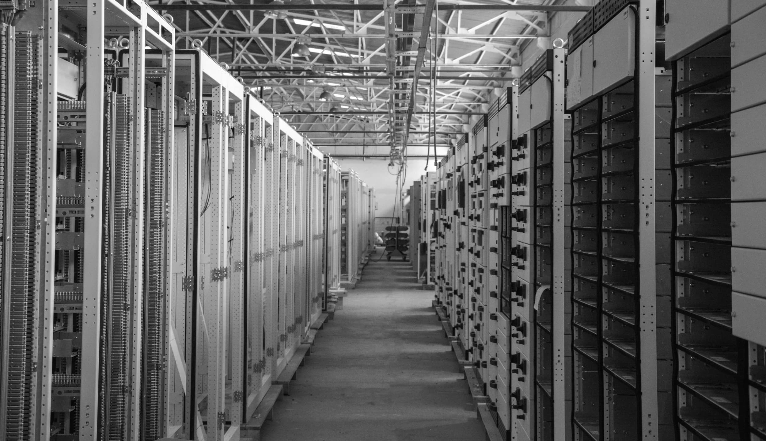 A hallway lined with server racks inside a data center